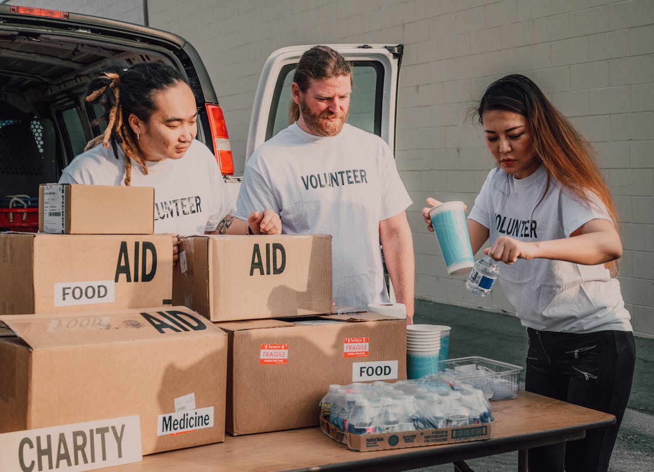 about-02 Volunteers sort aid and food boxes for a charity drive, promoting togetherness and social good.
